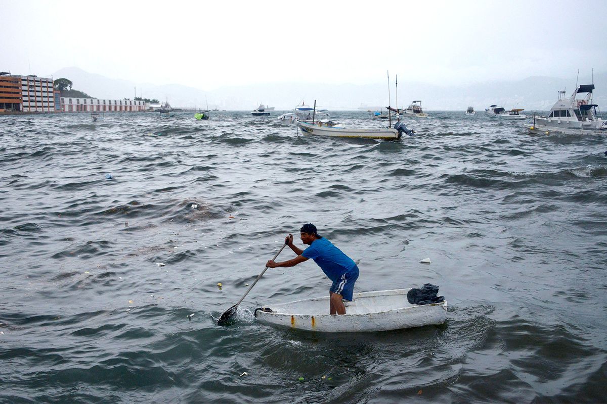 A man rows his boat in Acapulco, Guerrero State, Mexico, on August 16, 2023, following the passage of Tropical Storm Hilary. (Getty Images / FRANCISCO ROBLES / AFP)