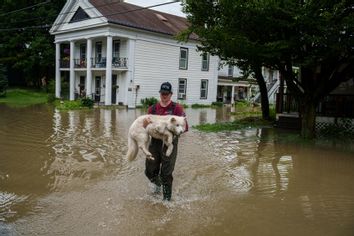 Vermont Flooding Man Carrying Dog 1526471658