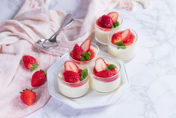 Creamy yogurt panna cotta with fresh strawberry sauce in glass